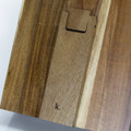 A wooden recipe book holder featuring a smooth finish and a branding logo, showcasing rich brown tones.