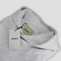 A grey hoodie with a hood and tags, featuring a logo on the tags.