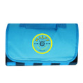 A blue picnic blanket with a folded design and a circular logo in the centre.