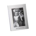 A classic aluminium photo frame in silver, featuring a black and white photo of two children. Includes a logo.