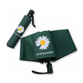 A green umbrella featuring a daisy design, packaged in a matching green sleeve with a logo.