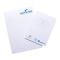 A notepad featuring lined pages, with a logo on the top and a smaller pad beside it, on a wooden surface.