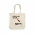 A cream tote bag with long handles featuring a logo, text, and a bat design in dark maroon.