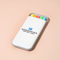 A highlighter set in a white case featuring yellow, orange, pink, and green highlighters, with a logo on the case.