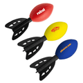 Three football-shaped rocket toys in red, yellow, and blue, each with black fins and featuring logos.