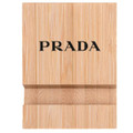 A bamboo phone holder in a natural wood finish featuring a logo on the front.