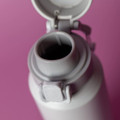 A drink bottle in grey with a cap and a spout, featuring a logo on the side.