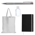A silver pen, a clear hand sanitizer bottle, a black notebook with an elastic band, and a plain white tote bag.