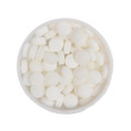 A round tin filled with small, round white mint candies.