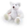 A soft, white plush teddy bear with pale yellow accents sitting with its arms and legs spread out.