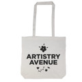 A tote bag with a long handle featuring the text "ARTISTRY AVENUE" and decorative floral elements.