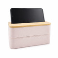 A pink eco lunch box with a bamboo lid and a phone holder, featuring a simple and modern design.
