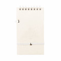A white notepad made from recycled materials, featuring a spiral binding and a secure closure. It includes a pen.