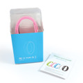 A pink pedometer bracelet in a box, with a user instruction booklet beside it.