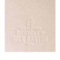 A cream-colored bookmark designed to resemble a milk carton, featuring embossed details and a logo.