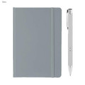 A grey A5 notebook with a matching elastic band and a silver pen beside it. The notebook features a logo on the cover.