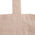 A beige calico tote bag featuring a long handle and a simple design. The bag has visible stitching details.