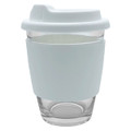 A glass coffee cup with a white silicone sleeve and lid, featuring a smooth, transparent design.
