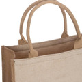 A tan reusable grocery bag with two sturdy handles and a simple, unlined design. It has a logo on one side.