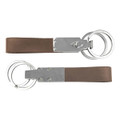 A brown leather multi key ring featuring silver metal accents and multiple rings for keys.