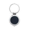 A matte black key ring with a circular design and a silver metal ring attachment.