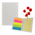 A sticky note pad with a speckled white cover, featuring bright pink, orange, green, and blue sticky notes, alongside red poppy flowers.