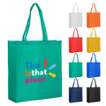 A green reusable grocery bag with a logo, displayed alongside bags in white, orange, red, yellow, blue, and black.