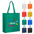 A green reusable grocery bag with two handles, featuring a logo, alongside bags in white, orange, red, yellow, blue, and black.