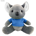 A grey koala plush toy wearing a blue shirt, featuring soft ears and a cute face, with a branding logo visible.