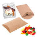 A pillow-shaped package containing assorted jelly lollies in various colours, accompanied by additional lollies on a surface.