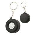 A black tyre-shaped key ring with a silver centre, featuring a metal chain and keyring attachment.