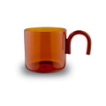 A transparent amber glass cup with a unique handle design, suitable for tea and coffee.