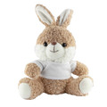 A soft, plush rabbit in light brown with a white belly, wearing a small white shirt. It has long ears and a friendly expression.
