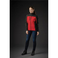 A woman is wearing a women's softshell jacket in red and black, with a zippered pocket, set against a dark background.