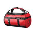 A red waterproof duffle bag with black accents and straps, featuring a logo and sturdy carry handles.