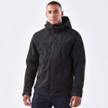 A black softshell jacket features a hood, zippered pockets, and a branding logo. Suitable for outdoor wear.