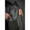 A woman's Oslo HD Parka in dark green, featuring a zipped inner pocket and a logo. 