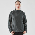 A woman wearing a dark grey women's Pacifica wind jacket with a hood, featuring a logo on the chest.
