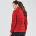 A red women's quilted jacket with a fitted design, displayed from the back. It features a collar and has a logo.