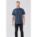 A short-sleeved, button-up shirt in navy blue featuring a subtle pattern, worn by a male model. It has a logo.
