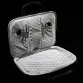 A grey laptop sleeve featuring a soft, padded interior and adjustable straps for securing a device.