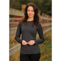 A woman wearing a long-sleeve dark grey t-shirt stands near a wooden fence in a natural setting. The shirt has a logo.