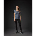 A woman stands in a navy blue crew neck t-shirt and black leggings, with a subtle logo on the shirt.