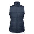 A navy women's thermal vest with a zip front, featuring a high collar and padded design. It has a branding logo.