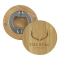 A drink bottle opener made of bamboo, featuring a circular design and a metal cap remover, with a logo.