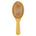 A bamboo hair brush in a light brown hue featuring a smooth handle and rounded bristles.