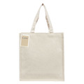 A cream-coloured tote bag with long handles, featuring a tag and a logo on the front.