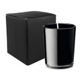 A black glass candle in a sleek holder, accompanied by a plain black box.