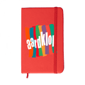 A red Minichroma A6 Notebook with a colourful design and an elastic band closure. It features a logo on the front.