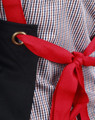 A black canvas bib apron with a red tie, featuring a grommet detail and a checkered fabric background.